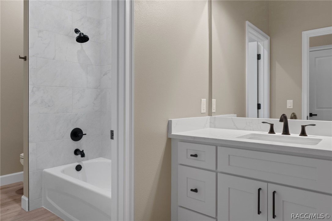 4530 South Florida Avenue Inverness, FL 34450 - Photo 33 of 100 a bathroom with a tub sink a mirror and shower