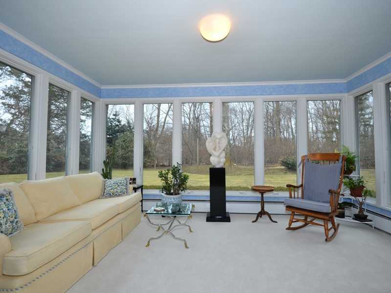 21 Cross Road Darien, CT 06820 - Photo 11 of 25 a living room with furniture and a large window