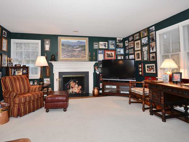 21 Cross Road Darien, CT 06820 - Photo 14 of 25 a living room with furniture a fireplace and a flat screen tv