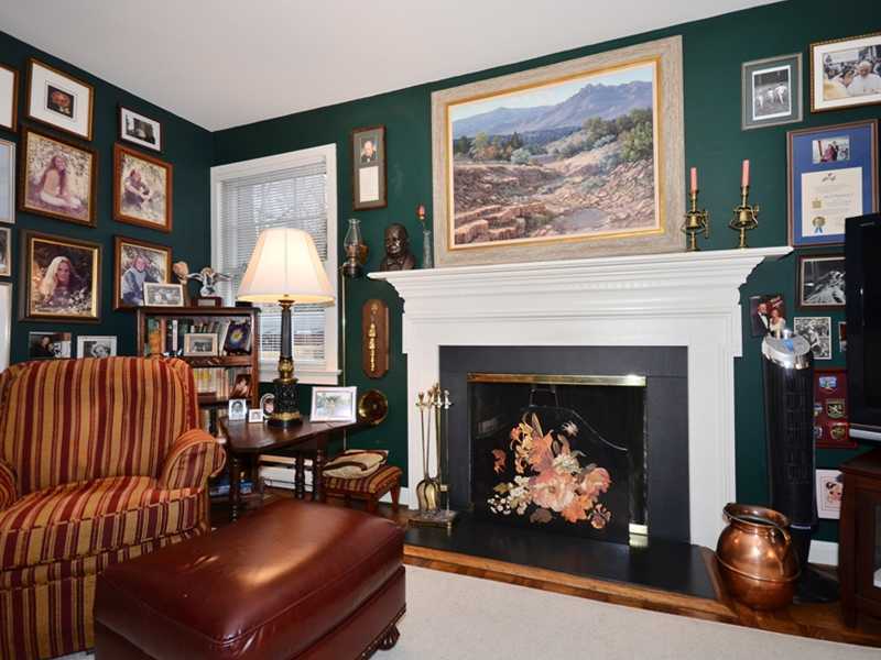 21 Cross Road Darien, CT 06820 - Photo 16 of 25 a living room with furniture a bookshelf and a fireplace