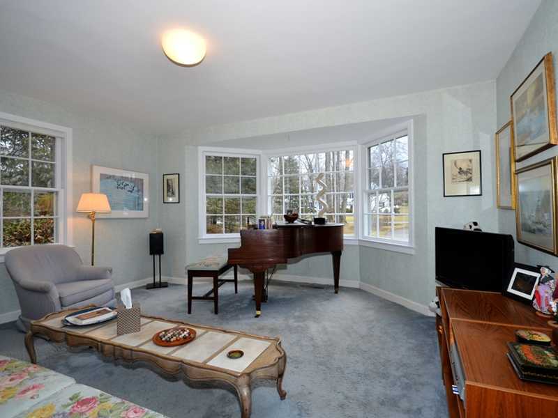 21 Cross Road Darien, CT 06820 - Photo 17 of 25 a living room with furniture a bookshelf and a window