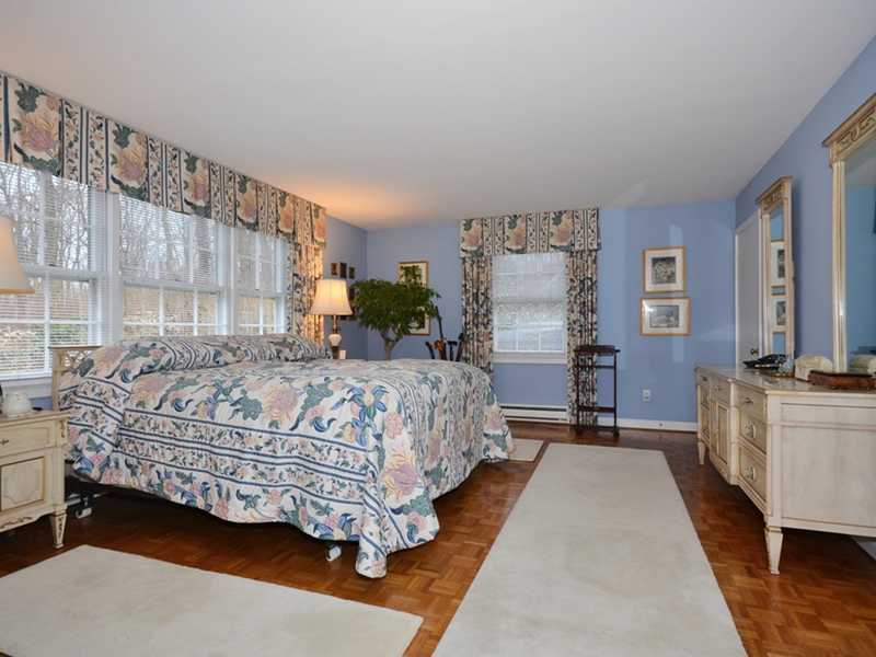 21 Cross Road Darien, CT 06820 - Photo 21 of 25 a bedroom with a bed couch and window