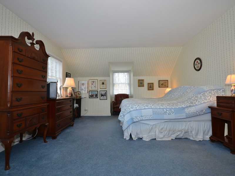 21 Cross Road Darien, CT 06820 - Photo 24 of 25 a spacious bedroom with a bed and a cabinets