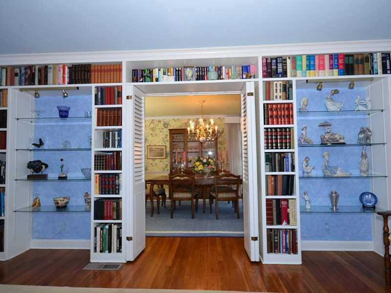 21 Cross Road Darien, CT 06820 - Photo 9 of 25 a living room with furniture and a book shelf