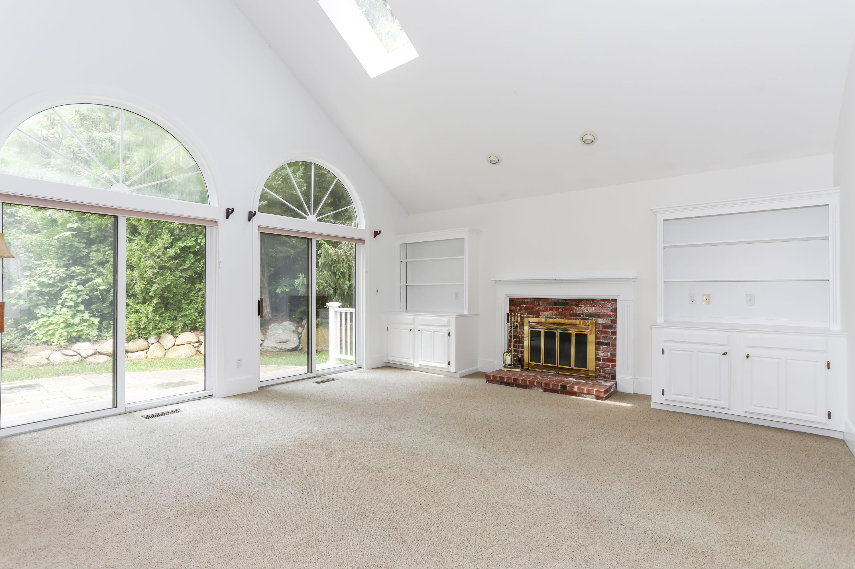 65 Trinity Place Centerville, MA 02632 - Photo 12 of 34 an empty room with windows and fireplace