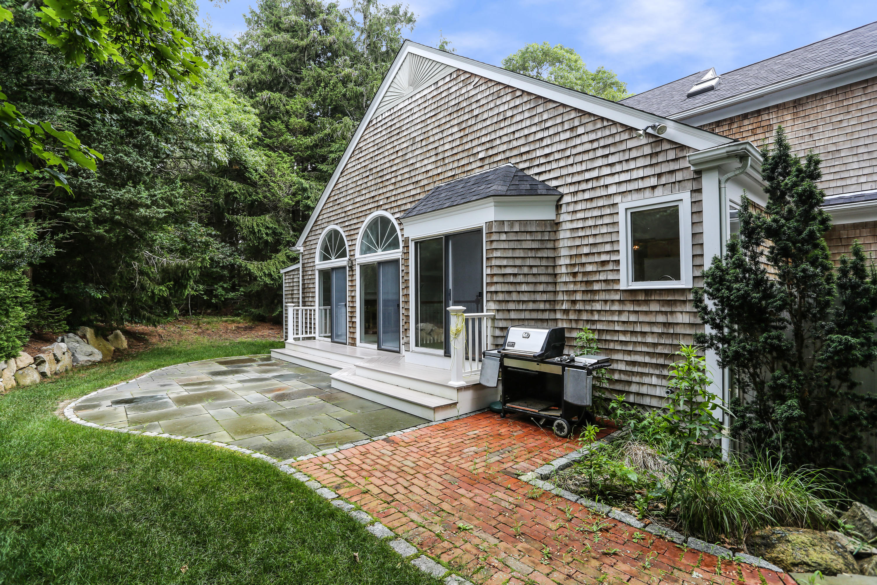 65 Trinity Place Centerville, MA 02632 - Photo 2 of 34 a view of a backyard with sitting area