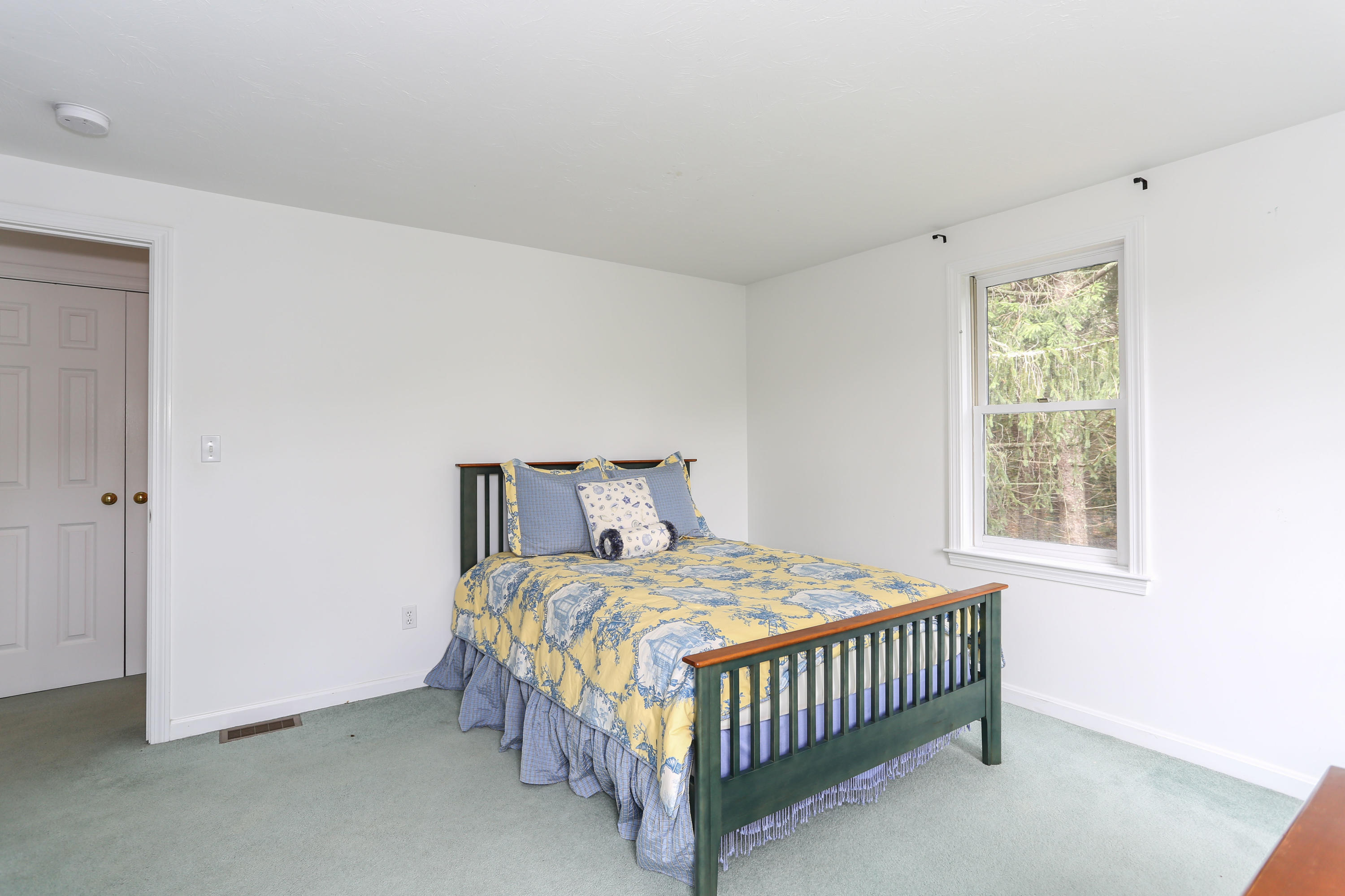 65 Trinity Place Centerville, MA 02632 - Photo 23 of 34 a bedroom with a bed and a window