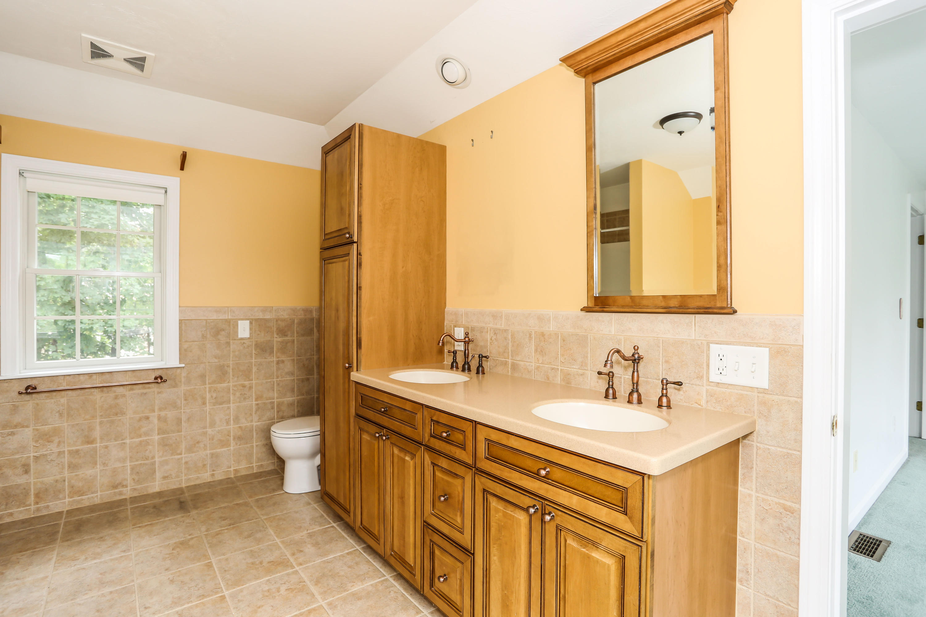 65 Trinity Place Centerville, MA 02632 - Photo 28 of 34 a bathroom with a sink mirror vanity and a toilet