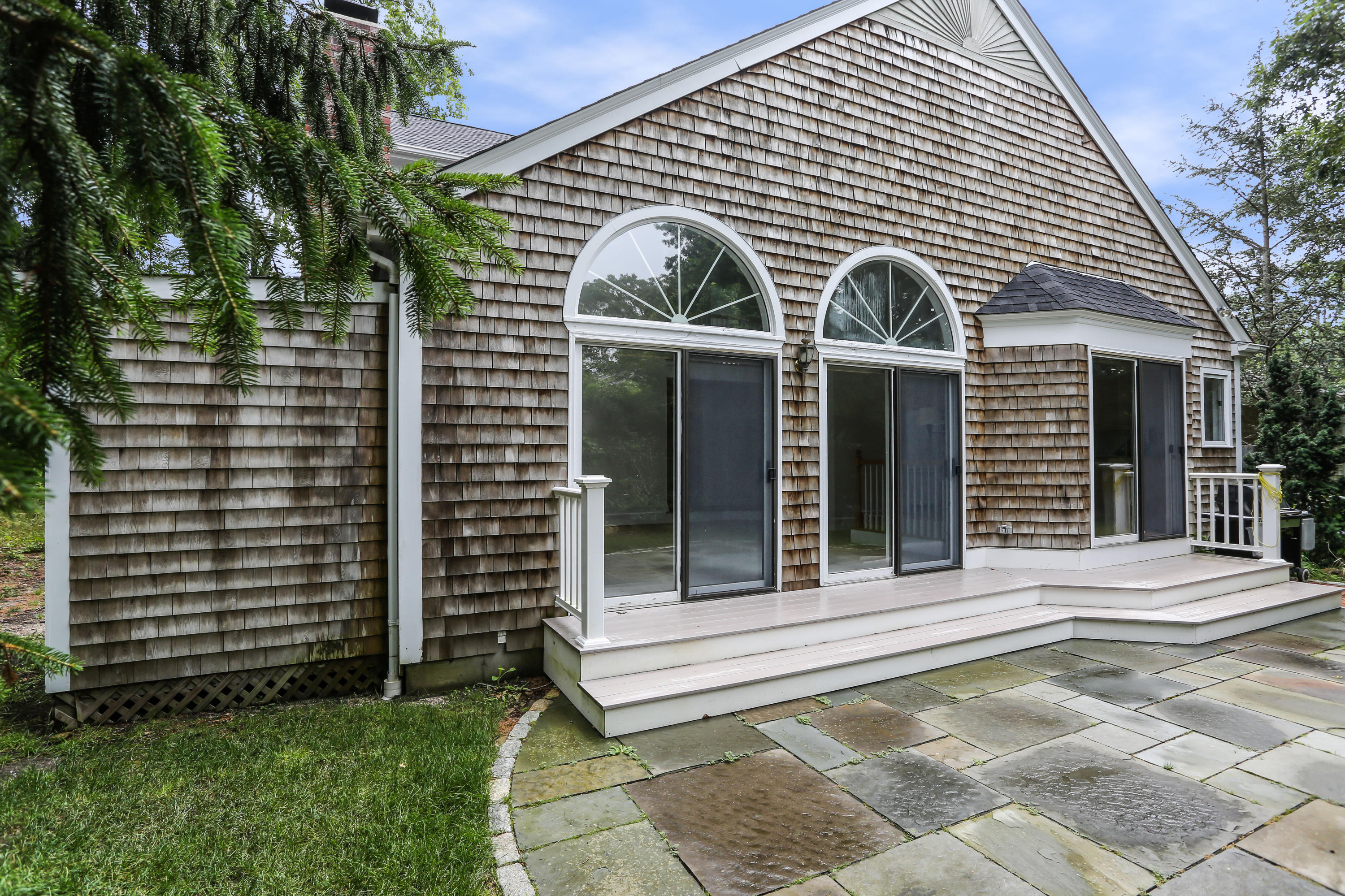 65 Trinity Place Centerville, MA 02632 - Photo 33 of 34 a front view of a house with a porch