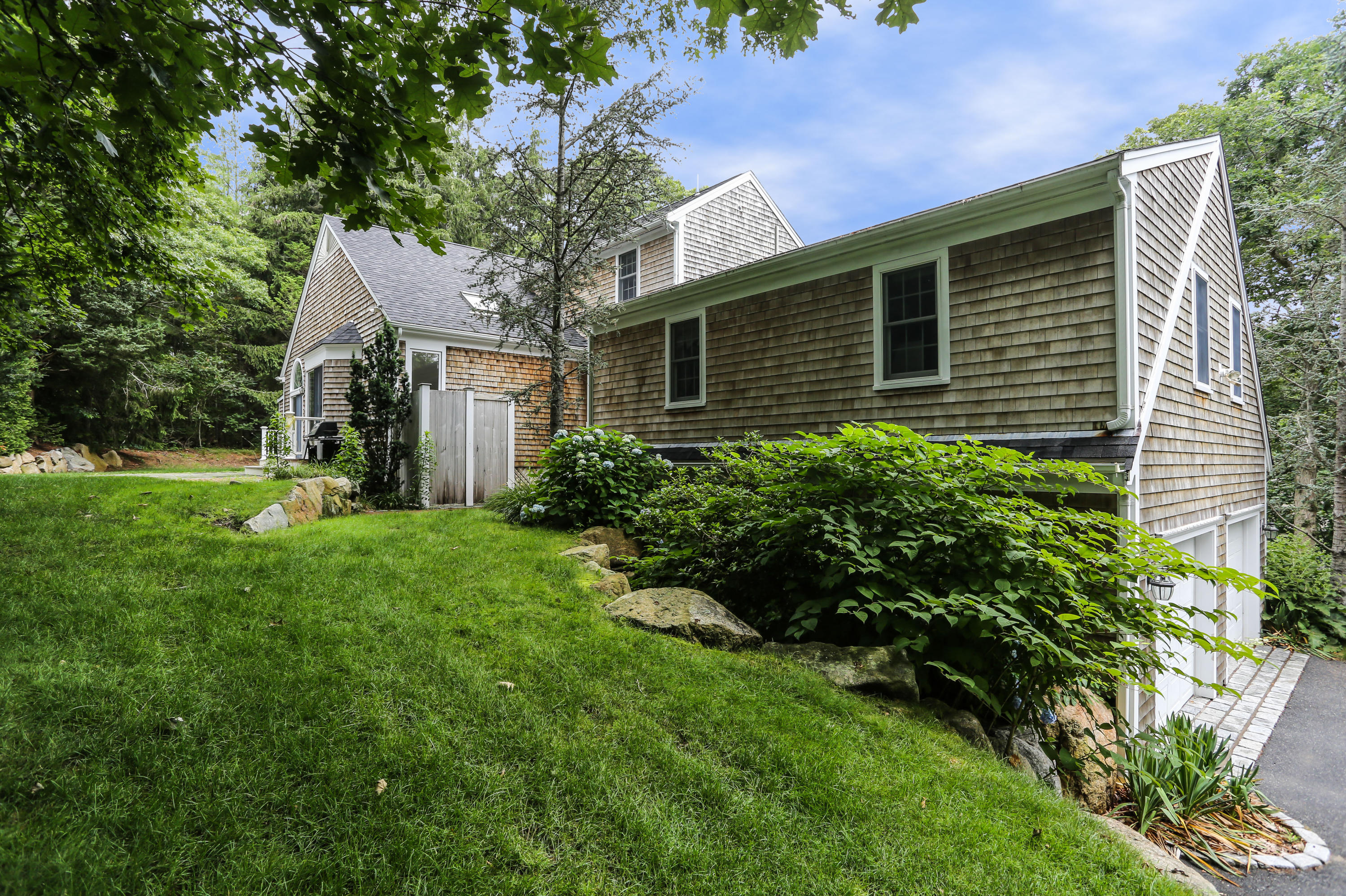 65 Trinity Place Centerville, MA 02632 - Photo 34 of 34 a backyard of a house with plants and large tree