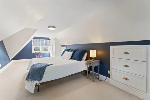 a spacious bedroom with a bed and window