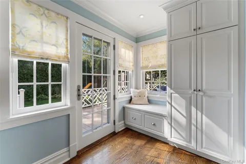 a large white bed in front of a window