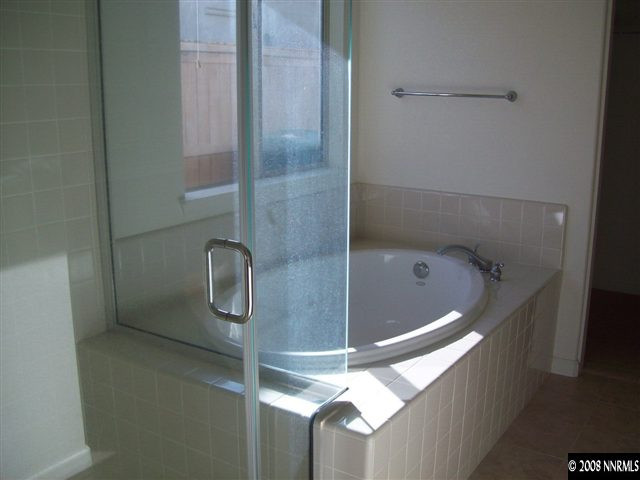 2705 Beach River Drive Reno, NV 89521 - Photo 8 of 9 a bathroom with a glass shower door