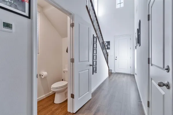 a dining area with stainless steel appliances kitchen island granite countertop a dining table chairs and stove top oven with wooden floor