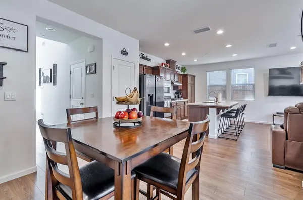 a kitchen with stainless steel appliances granite countertop a refrigerator and a stove top oven