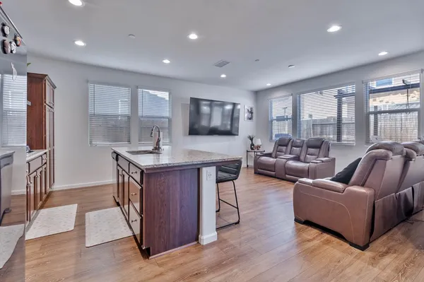 a kitchen view with granite countertop a stove and a refrigerator