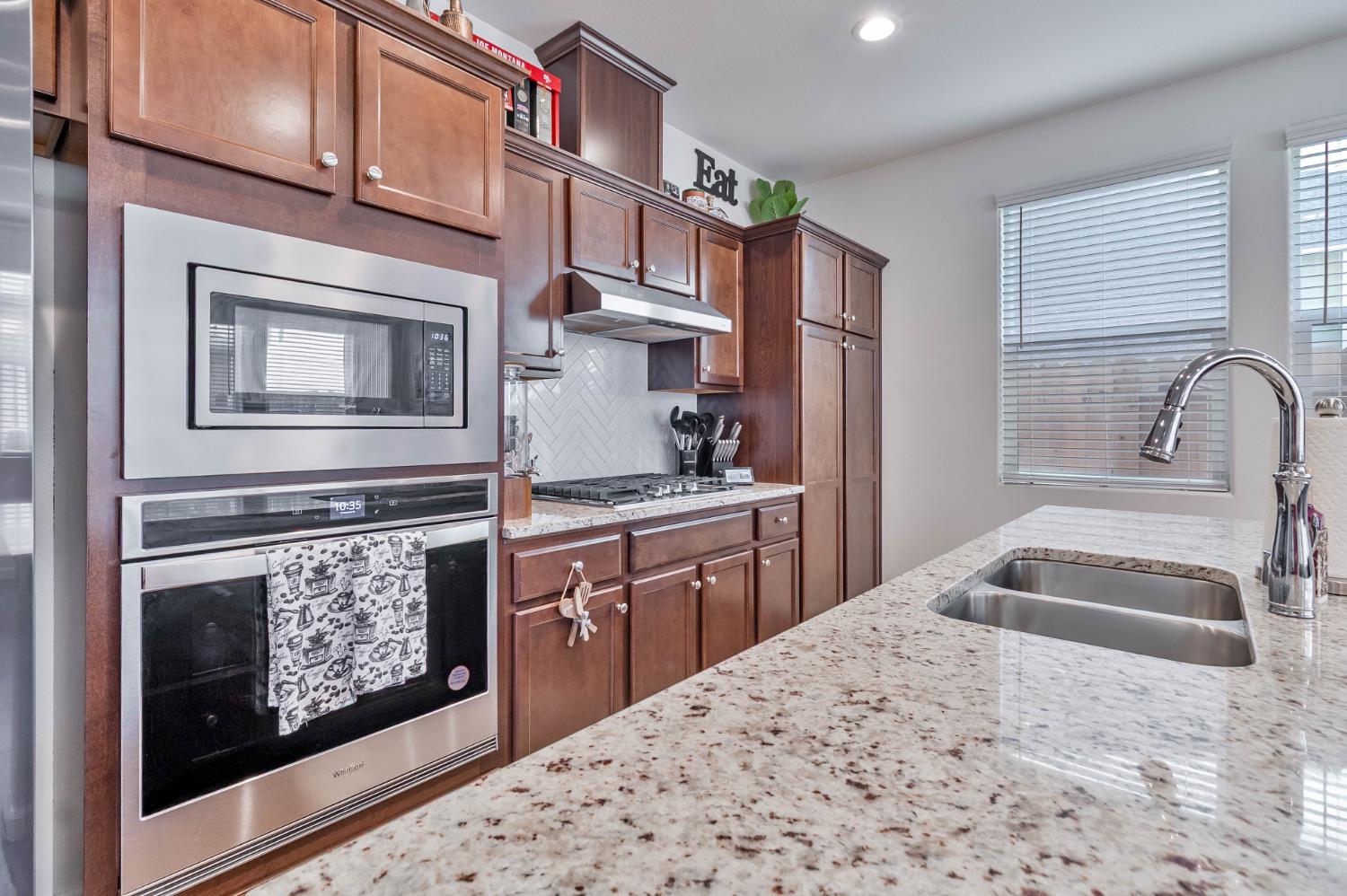 915 Winchell Way West Madera, CA 93636 - Photo 19 of 42 a kitchen view with granite countertop a stove and a refrigerator