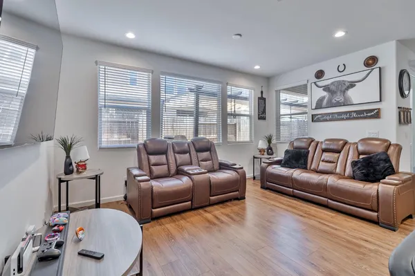 a living room with furniture and a wooden floor