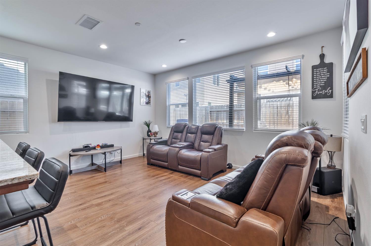 915 Winchell Way West Madera, CA 93636 - Photo 23 of 42 a living room with furniture a flat screen tv and wooden floor