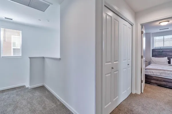 a bedroom with a bed and a large window