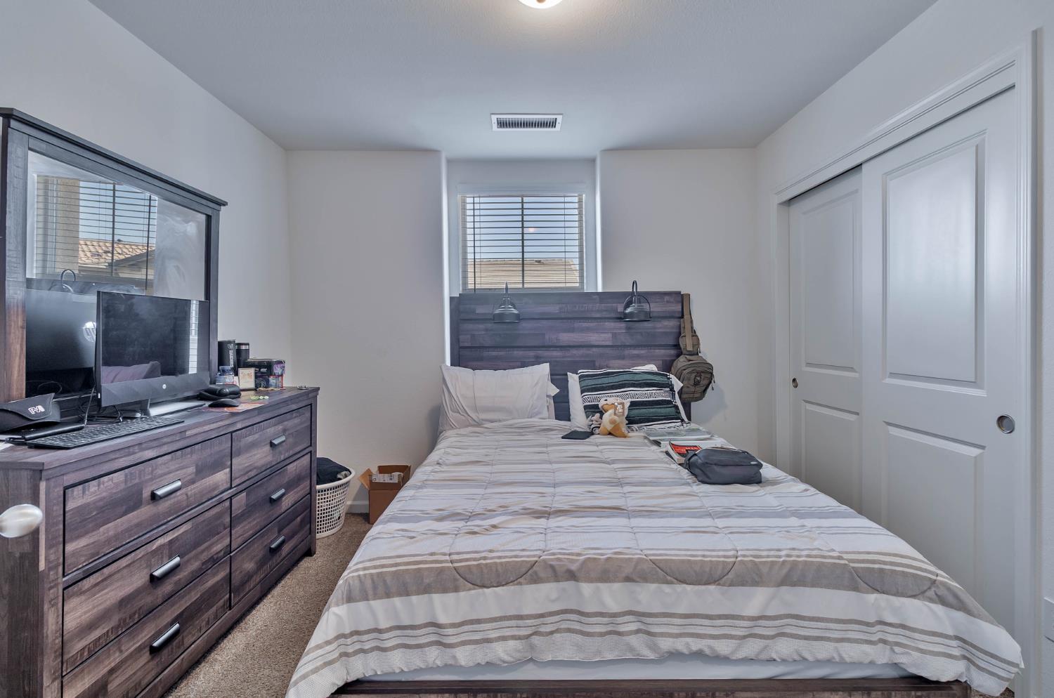 915 Winchell Way West Madera, CA 93636 - Photo 33 of 42 a bedroom with a bed and a flat screen tv