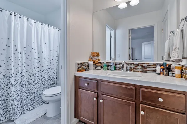 a living room with furniture a couch and large windows