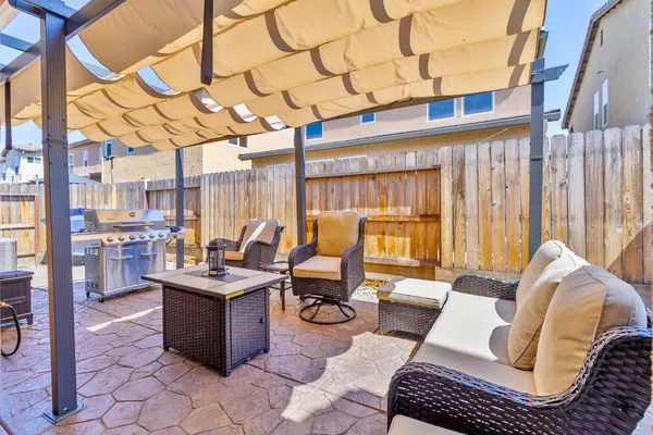 a backyard of a house with yard and outdoor seating