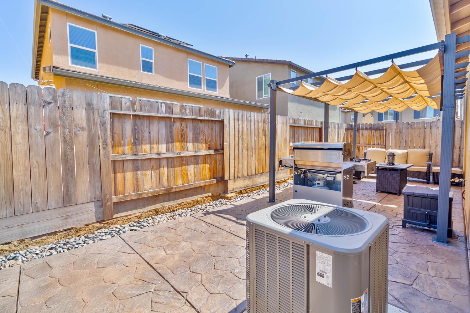 915 Winchell Way West Madera, CA 93636 - Photo 41 of 42 a backyard of a house with yard and outdoor seating