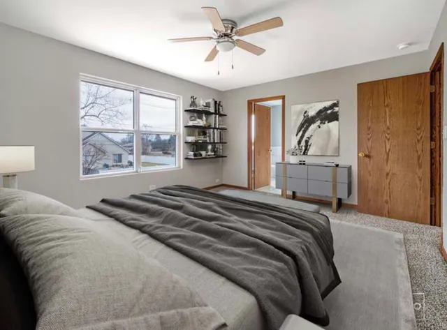 a bedroom with a bed and a painting on the wall