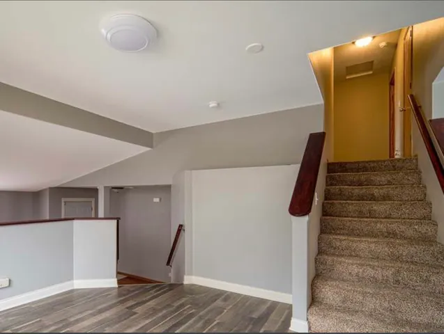 a view of entryway and hall with wooden floor