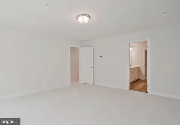 a view of an empty room and a window