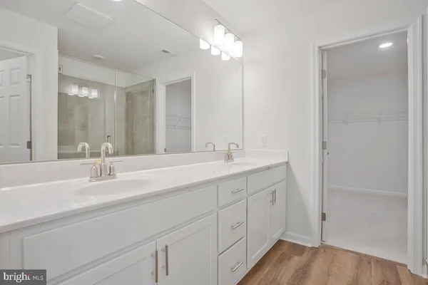 a bathroom with double vanity sink and a mirror
