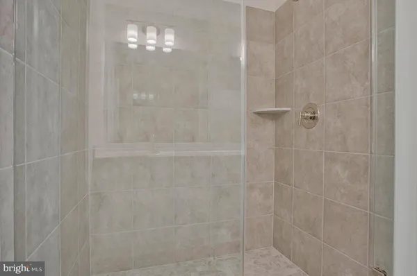 a bathroom with a glass shower door
