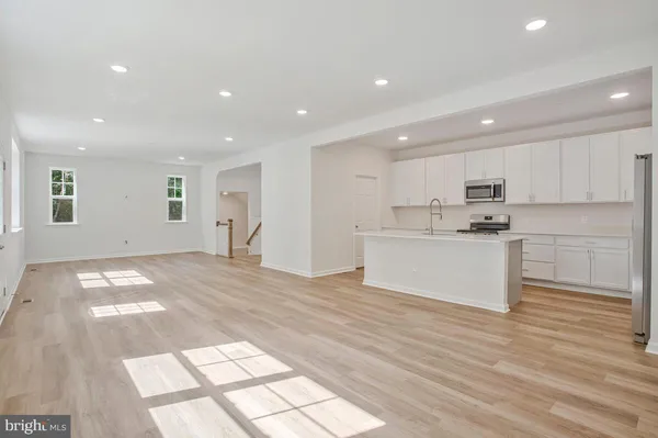 a view of kitchen with granite countertop cabinets and wooden floor