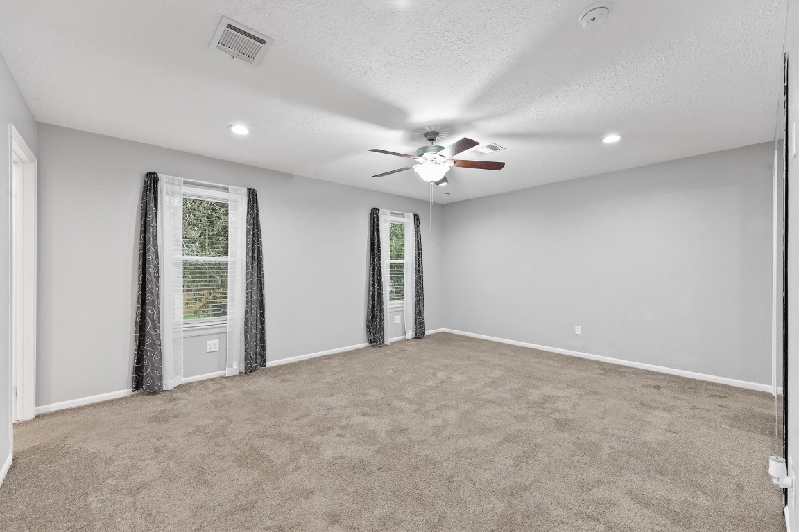 3702 Ember Spring Drive Houston, TX 77339 - Photo 16 of 27 a view of an empty room with a chandelier fan