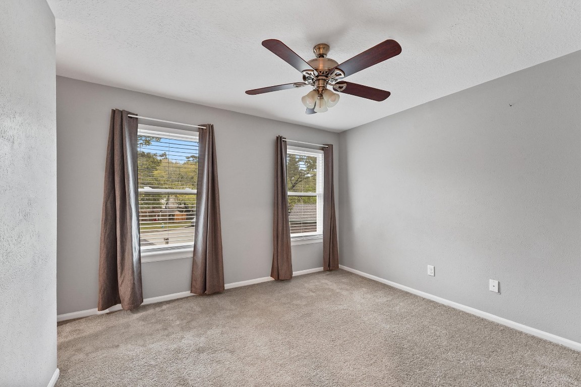 3702 Ember Spring Drive Houston, TX 77339 - Photo 19 of 27 an empty room with closet and fan
