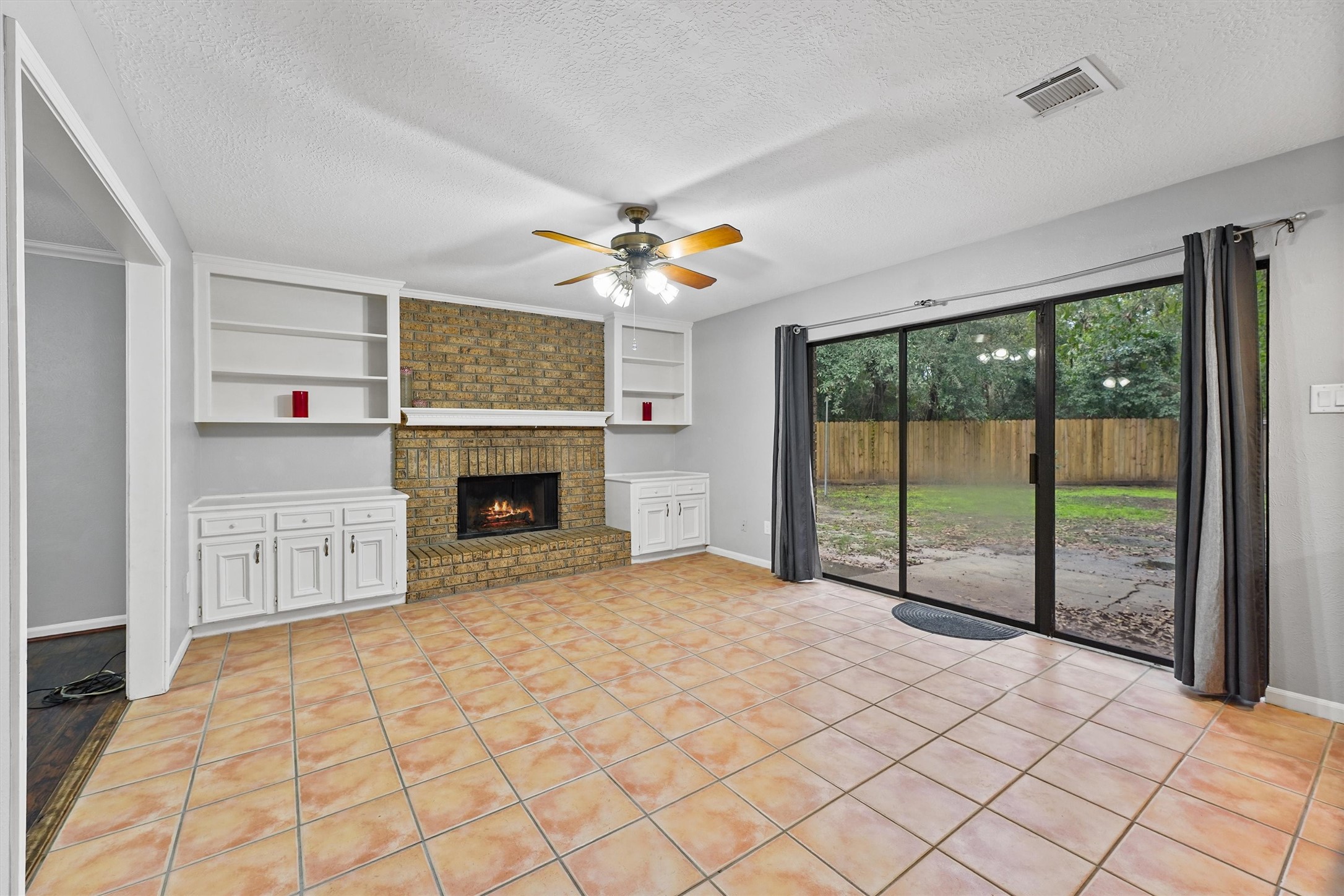 3702 Ember Spring Drive Houston, TX 77339 - Photo 2 of 27 a view of a livingroom with a fireplace and large windows