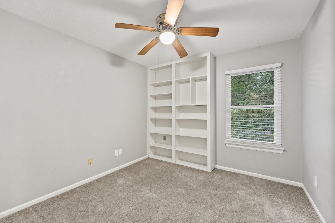 3702 Ember Spring Drive Houston, TX 77339 - Photo 21 of 27 an empty room with a ceiling fan and a window
