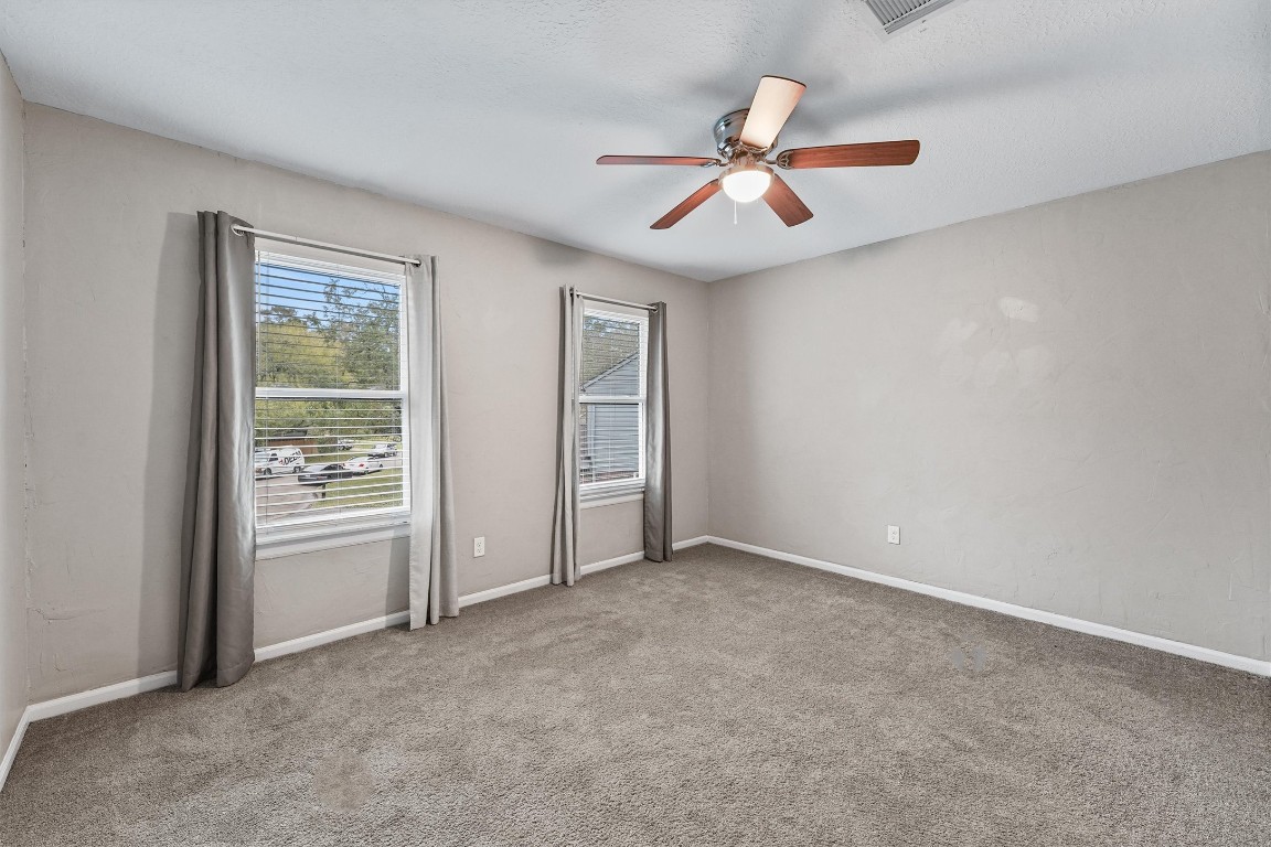 3702 Ember Spring Drive Houston, TX 77339 - Photo 22 of 27 a view of an empty room with chandelier fan and fire place