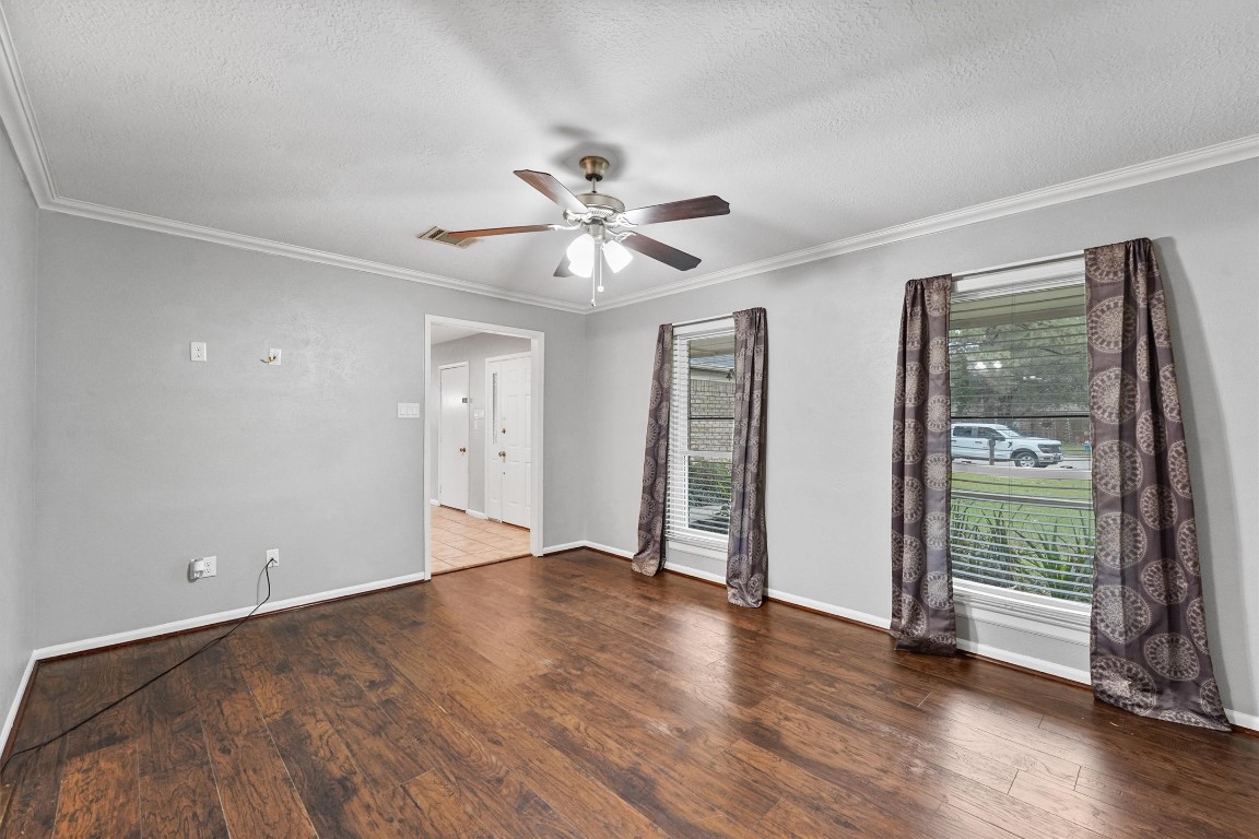 3702 Ember Spring Drive Houston, TX 77339 - Photo 9 of 27 an empty room with wooden floor and a ceiling fan