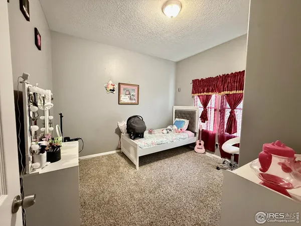 a living room with furniture and gym equipment