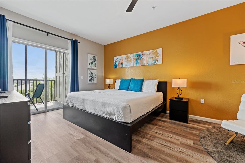 14200 Avalon Road, Unit 409 Winter Garden, FL 34787 - Photo 15 of 33 a bedroom with a bed and wooden floor