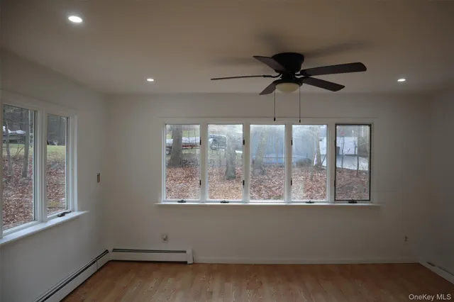 a view of a room with a window and a ceiling fan