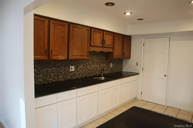 a kitchen with white cabinets
