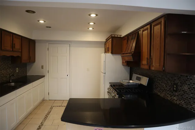 a kitchen with sink and refrigerator