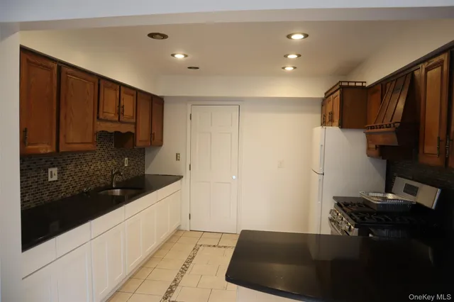 a kitchen with a sink and a refrigerator