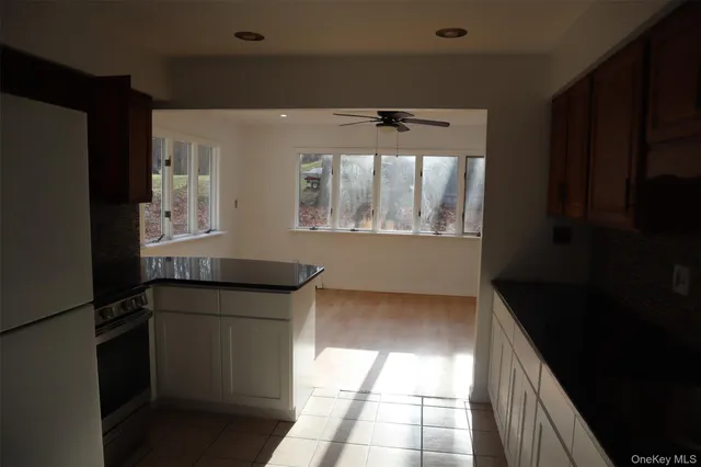 a kitchen with granite countertop a refrigerator and a stove