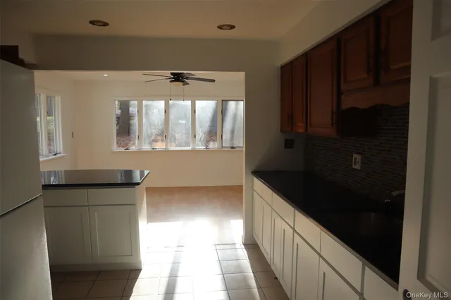 a kitchen with granite countertop a refrigerator and a sink
