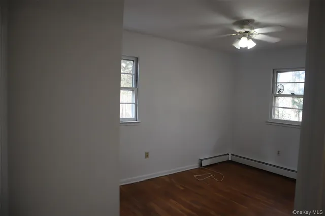 a view of a room with wooden floor and a window
