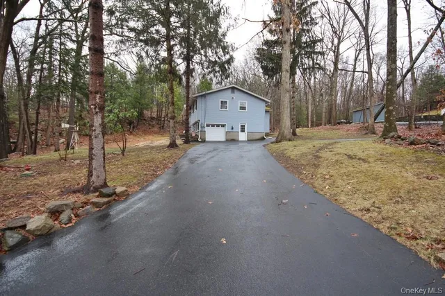 a view of a house with a yard covered in snow